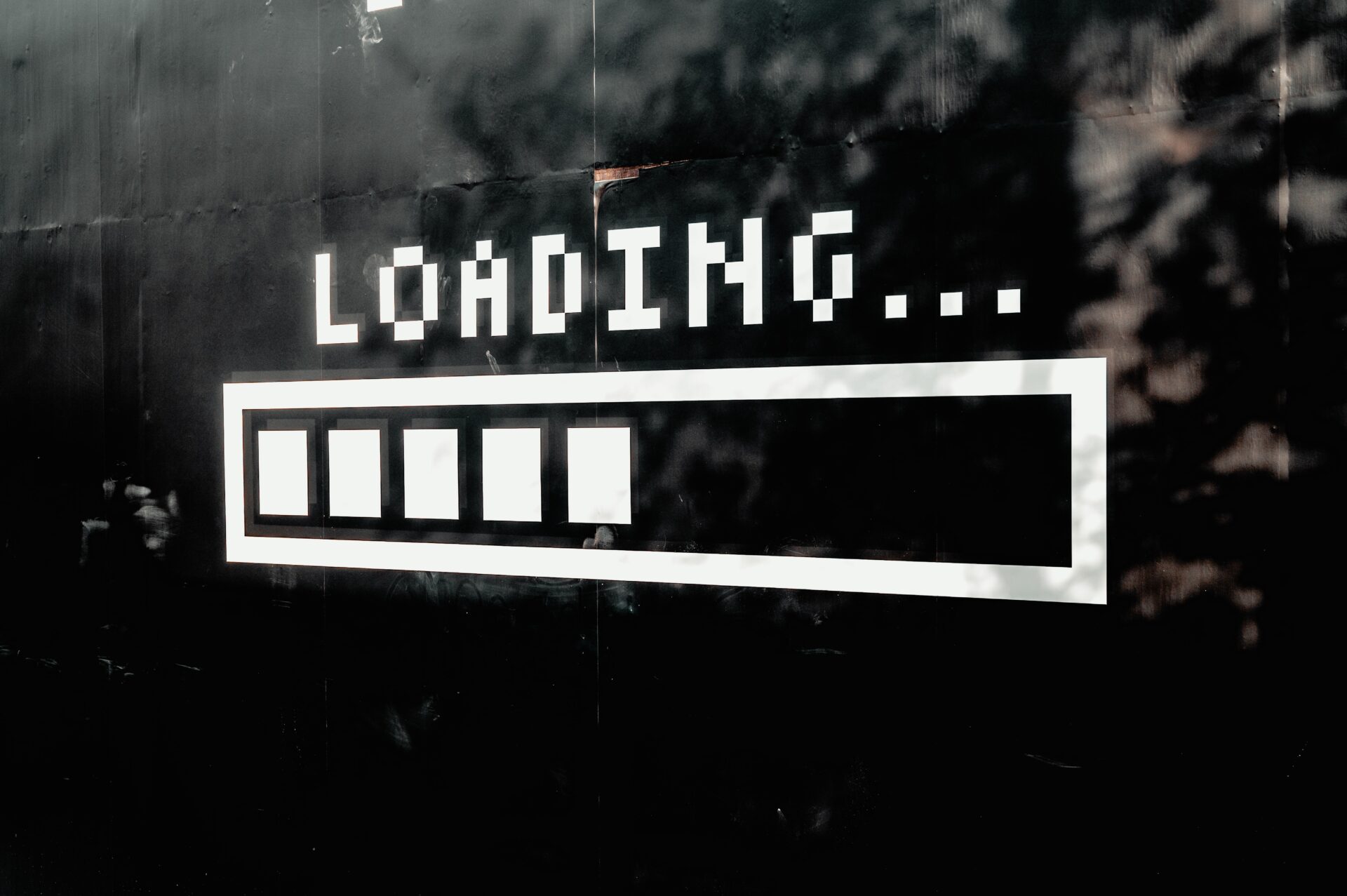 Progress bar with the word 'loading' above it (Photo by Mike van den Bos on Unsplash)