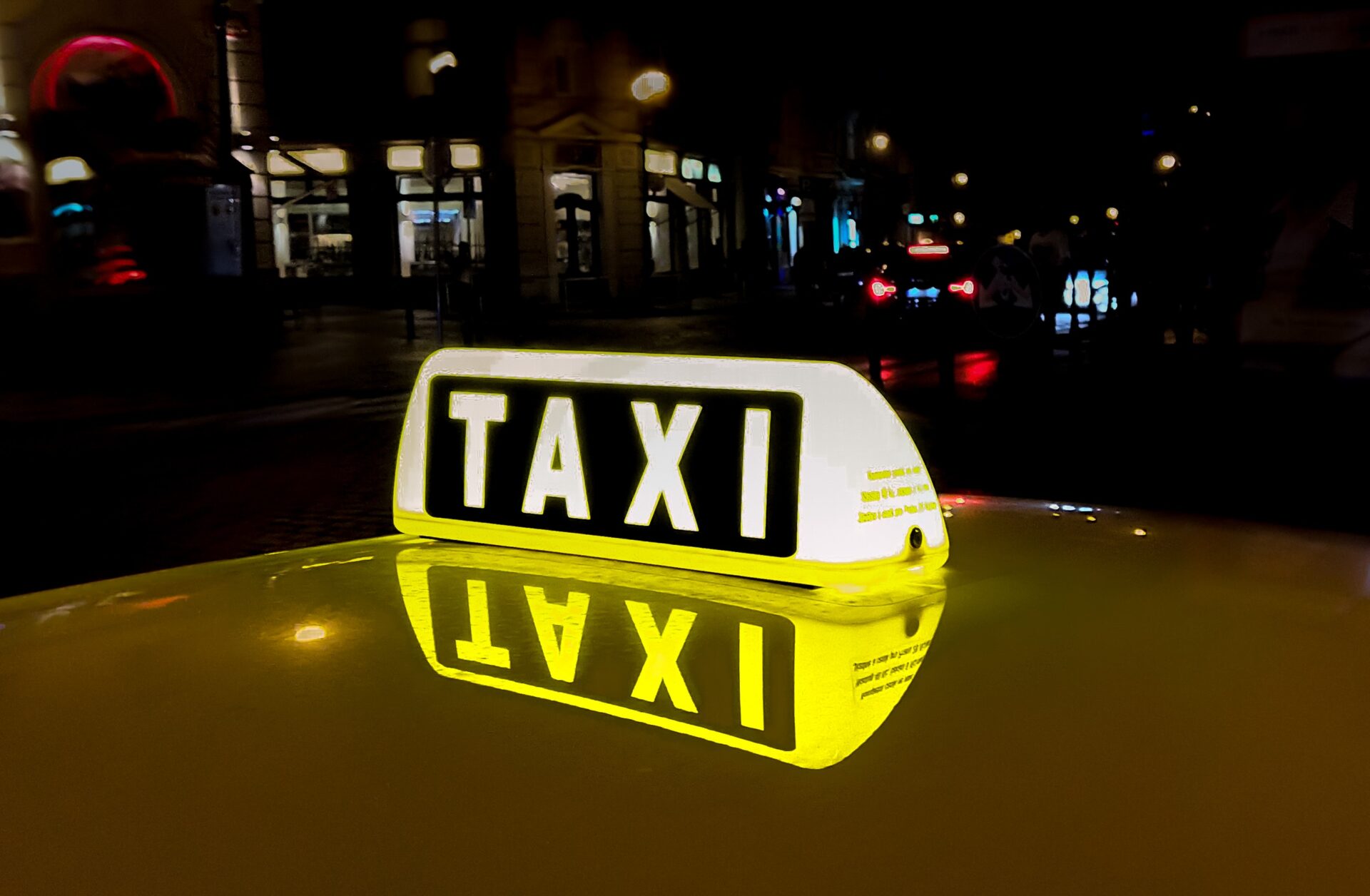 Lighted taxi sign at night (Photo by Skitterphoto from Pexels)