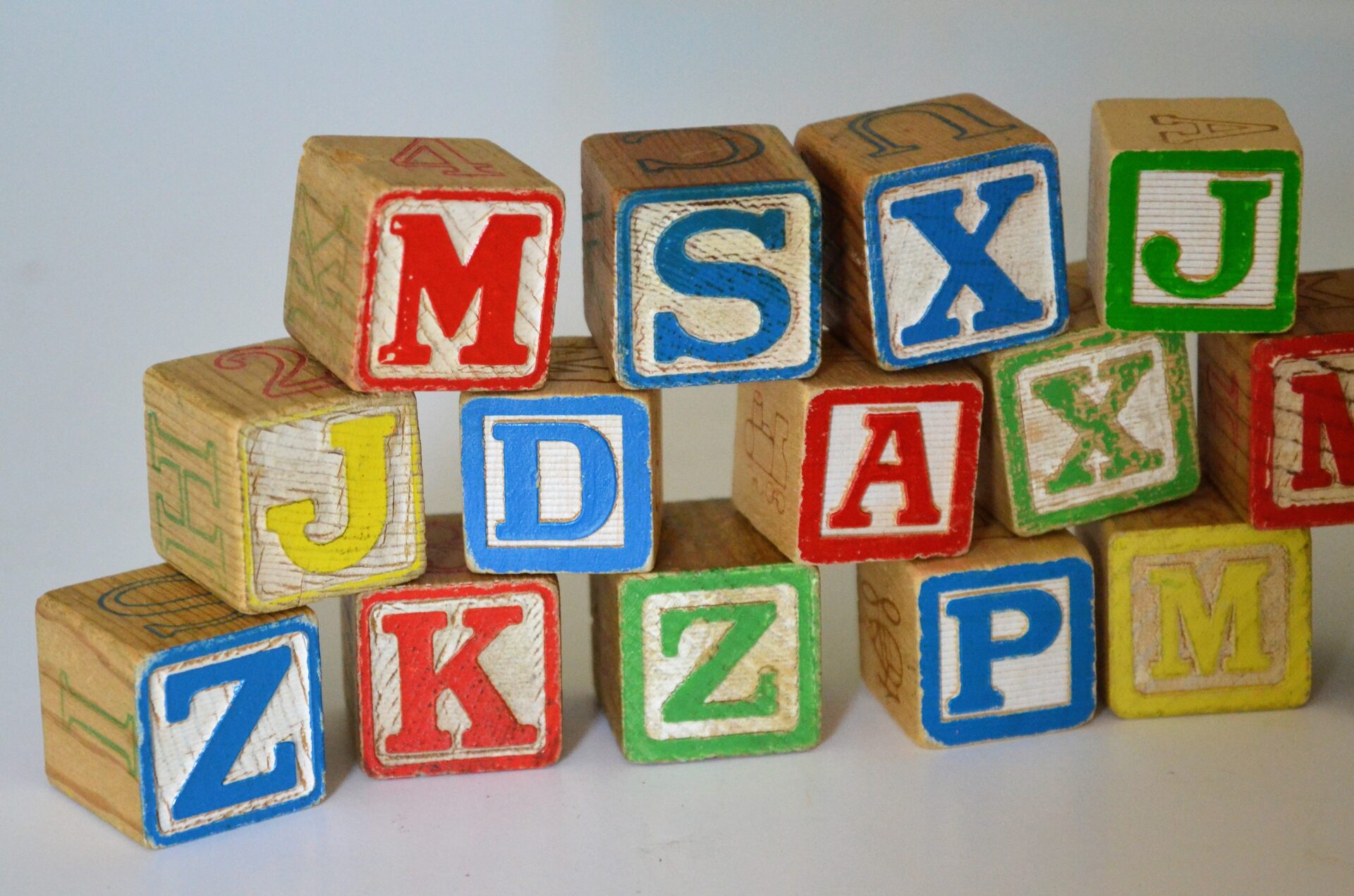Pile of wooden blocks with letters on (Photo by Susan Holt Simpson on Unsplash)