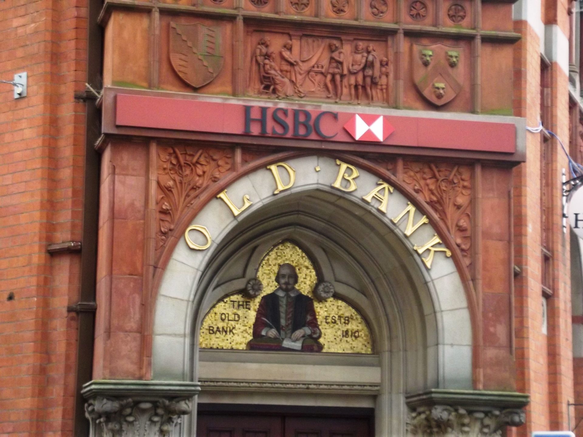Ornate archway over the door of The Old Bank established 1810, now rebranded as HSBC Bank (Photo by Elliott Brown)