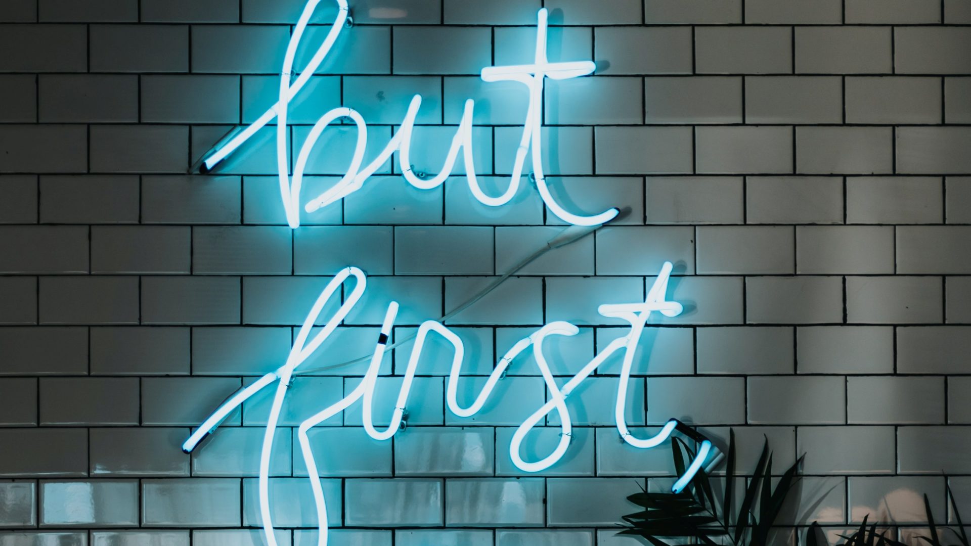 Neon sign saying "but first"