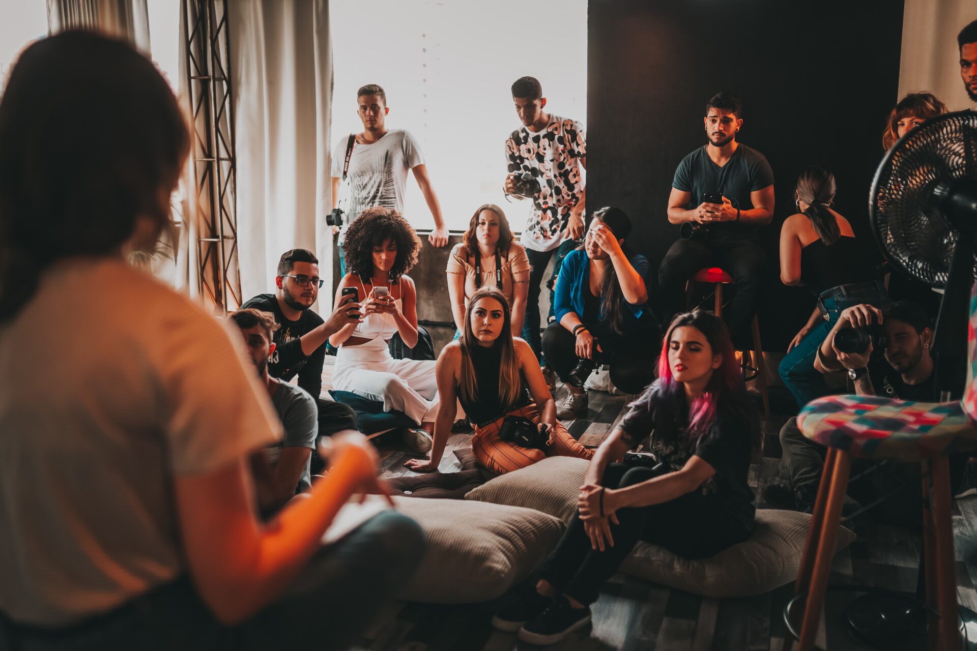 Audience gathering round a female speaker in studio (Photo by Matheus Bertelli on Pexels)