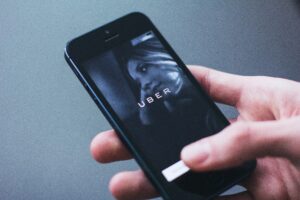 Person holding smartphone with Uber logo on screen (Photo by freestocks.org from Pexels)