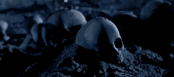 An animated gif of a scene from the film Terminator 2 in which a metal robot crushes a bleached human skull underfoot