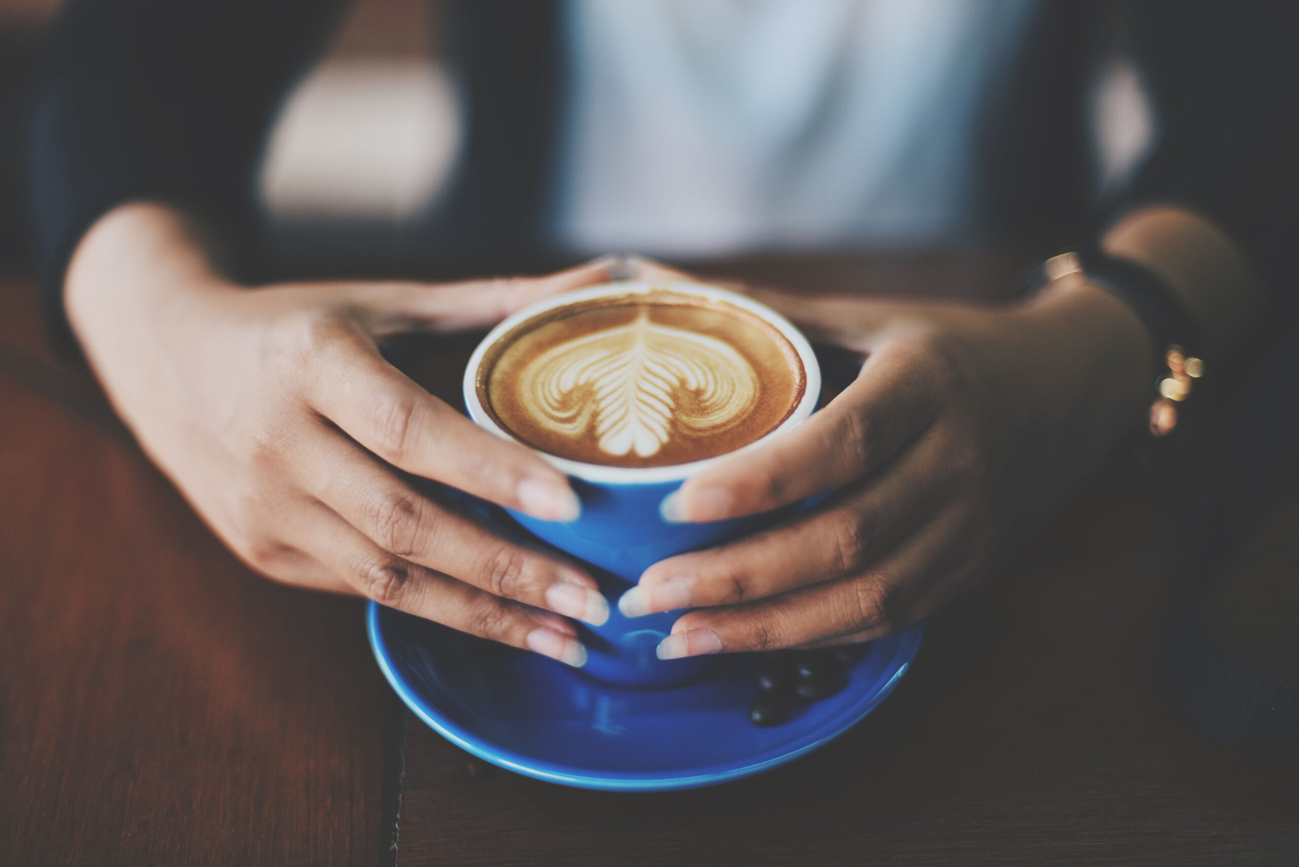 Person holding blue coffee cup. Photo by Chevanon Photography on Pexels.com